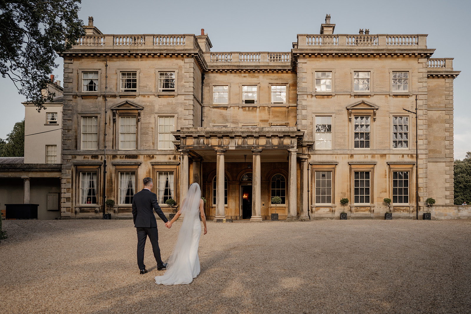 wedding couple walk in sunset at prestwold hall statel home venue