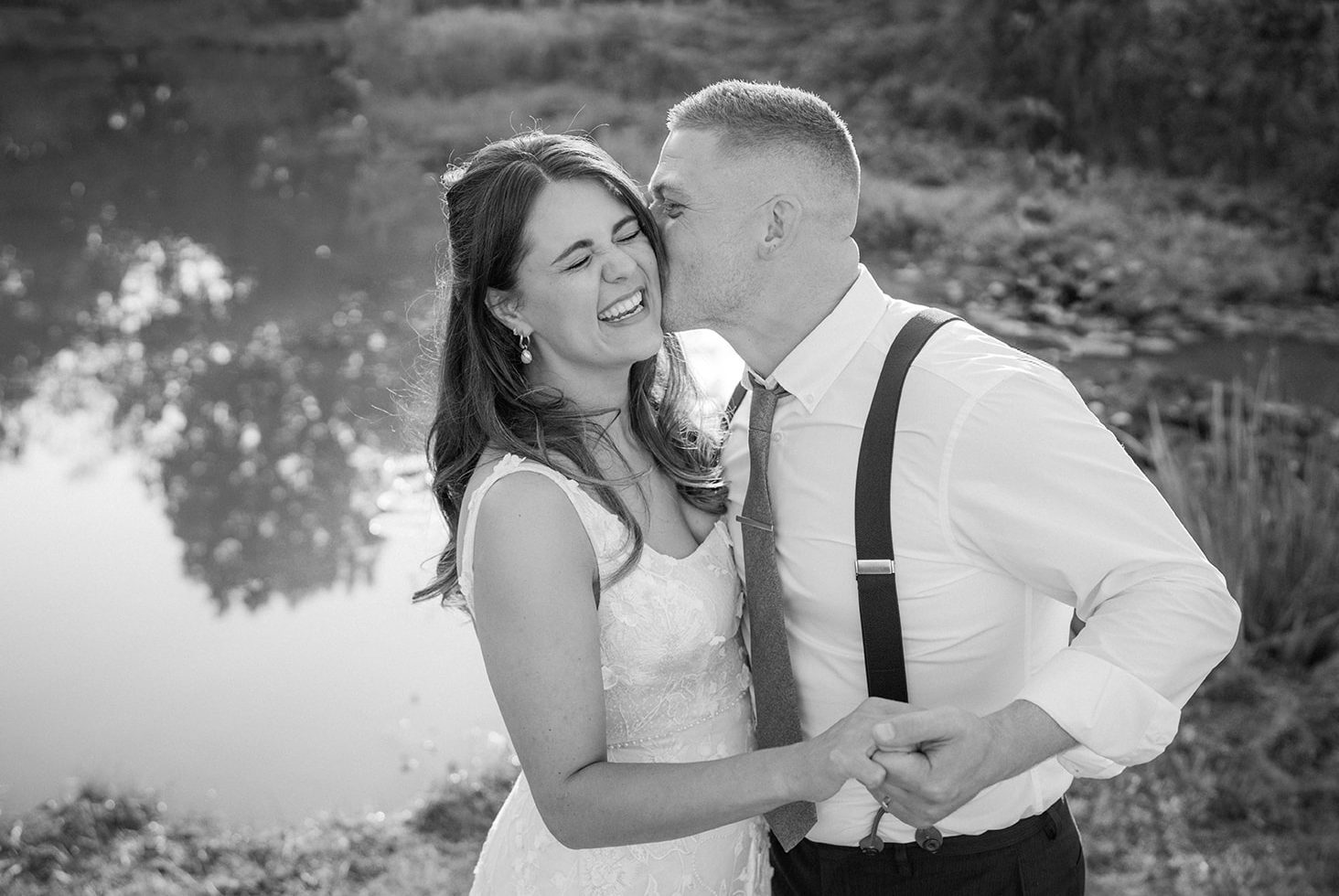 a bride and groom laughing captured by a nottingham wedding photographer